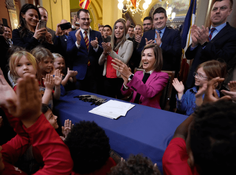 Iowa Governor Kim Reynolds reacts after signing a bill that creates education savings accounts, Tuesday, Jan. 24, 2023, at the Statehouse in Des Moines, Iowa.